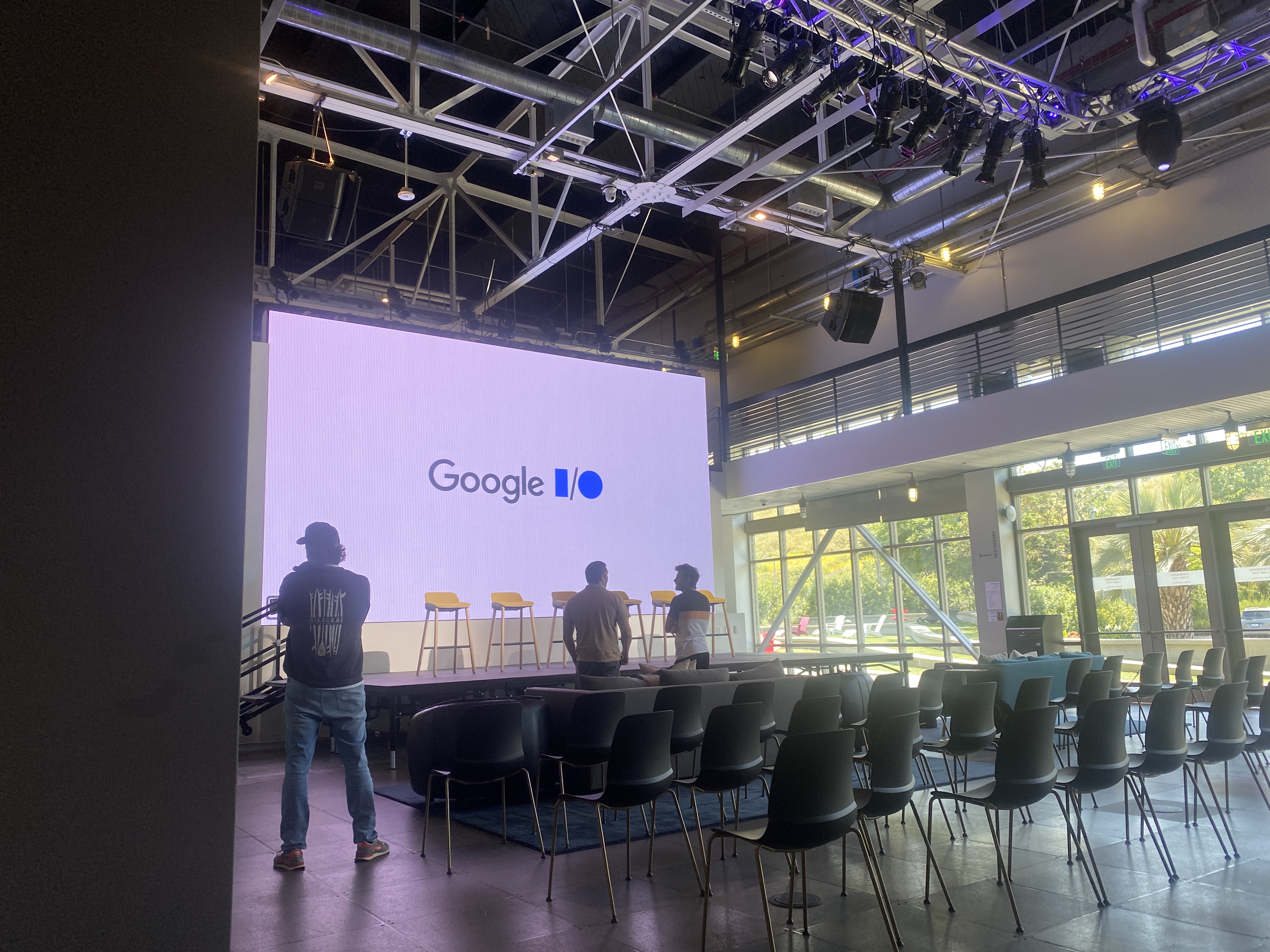 Google I/O event setup - professional venue with large screen, staging, and audience seating demonstrating large-scale event production
